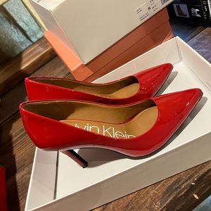 Women’s Calvin Klein heels Red in color size 5  4” heel great condition.